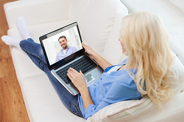 Image showing smiling woman with laptop computer at home