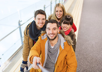 Image showing happy friends taking selfie on skating rink