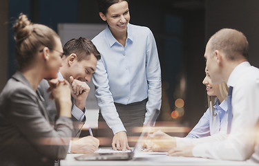 Image showing smiling female boss talking to business team