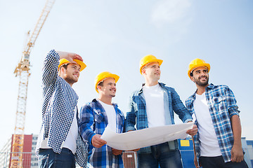 Image showing group of builders with tablet pc and blueprint