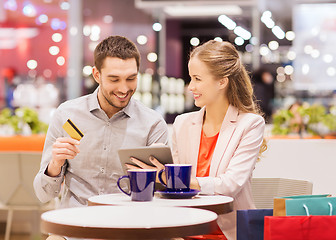 Image showing couple with tablet pc and credit card in mall