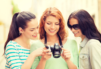 Image showing smiling teenage girls with camera