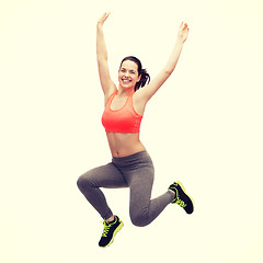 Image showing sporty teenage girl jumping in sportswear