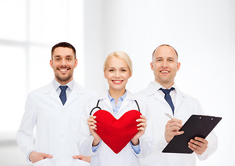 Image showing group of smiling doctors with heart and clipboard