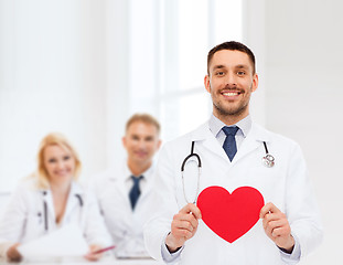 Image showing smiling male doctor with red heart