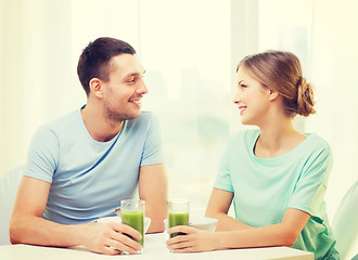 Image showing smiling couple having breakfast at home