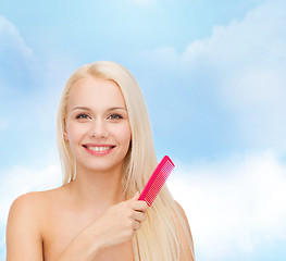 Image showing smiling woman with hair brush