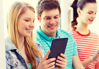 Image showing smiling students with tablet pc at school