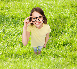 Image showing smiling little girl in black eyeglasses