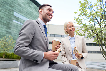 Image showing smiling businessmen with paper cups outdoors