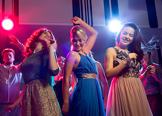 Image showing smiling friends dancing in club