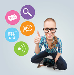 Image showing smiling teen girl sitting on floor with tablet pc