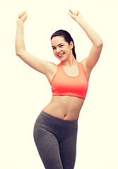 Image showing smiling teenage girl in sportswear dancing