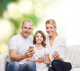 Image showing happy family with smartphones