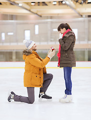 Image showing happy couple with engagement ring on skating rink