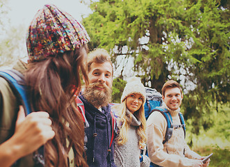 Image showing group of friends with backpacks and tablet pc