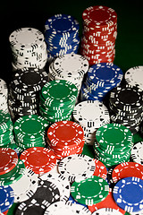 Image showing close up of casino chips on green table surface