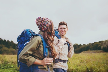 Image showing smiling couple with backpacks hiking