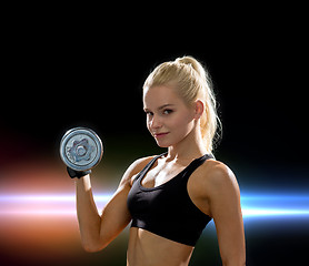 Image showing young sporty woman with heavy steel dumbbell