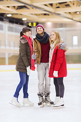 Image showing happy friends taking selfie on skating rink