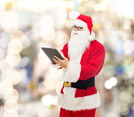 Image showing man in costume of santa claus with tablet pc