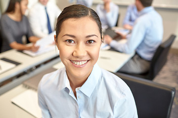 Image showing group of smiling businesspeople meeting in office