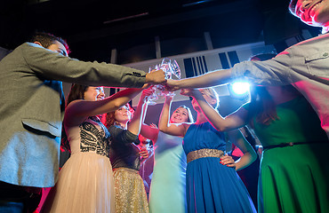 Image showing smiling friends with glasses of champagne in club