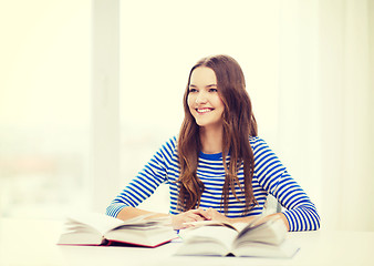 Image showing happy smiling student girl with books