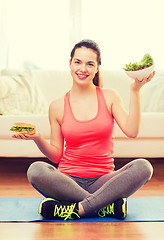 Image showing smiling teenager with green salad and hamburger