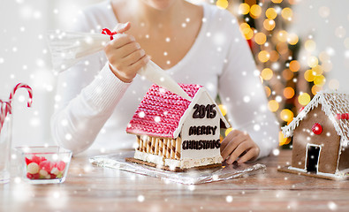 Image showing close up of woman making gingerbread houses