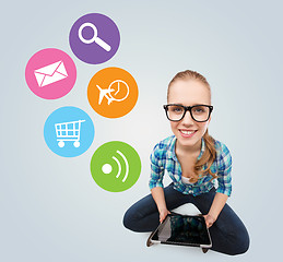 Image showing smiling teen girl sitting on floor with tablet pc