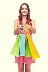 Image showing smiling woman in dress with many shopping bags