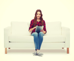 Image showing teenage girl sitting on sofa with tablet pc