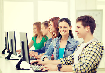 Image showing smiling student with computer studying at school