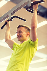 Image showing smiling man exercising in gym