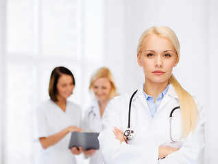 Image showing serious female doctor with stethoscope