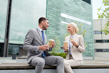 Image showing smiling businessmen with paper cups outdoors