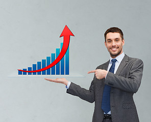 Image showing happy man showing growth chart on palm of his hand