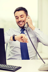 Image showing smiling businessman making call