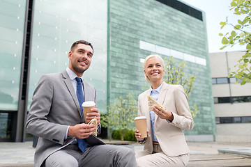 Image showing smiling businessmen with paper cups outdoors