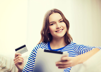 Image showing smiling girl with tablet pc and credit card