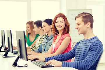 Image showing smiling student with computer studying at school