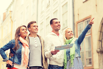 Image showing group of smiling friends with map and photocamera