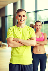 Image showing smiling man and woman in gym