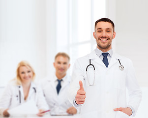 Image showing smiling doctor with stethoscope showing thumbs up