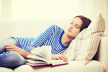 Image showing smiling teenage girl sleeping on sofa at home