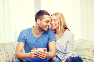 Image showing smiling man with cup of tea or coffee with wife