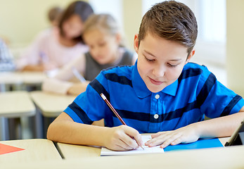 Image showing group of school kids writing test in classroom