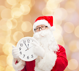 Image showing man in costume of santa claus with clock