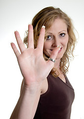 Image showing Happy woman holding up hand wearing thumb ring